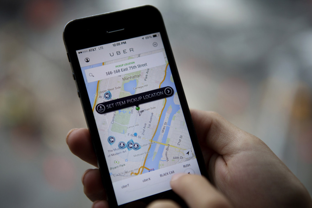 Th Uber Technologies Inc. car service application (app) is demonstrated for a photograph on an Apple Inc. iPhone in New York, U.S., on Wednesday, Aug. 6, 2014. For San Francisco-based Uber Technologies Inc. which recently raised $1.2 billion of investors' financing at $17 billion valuation, New York is its biggest by revenue among the 150 cities in which it operates across 42 countries. The Hamptons are a pop-up market for high-end season weekends where the average trip is three time that of an average trip in New York City. Photographer: Victor J. Blue/Bloomberg via Getty Images