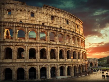 One of the most popular travel place in world – Roman Coliseum under evening sun light and sunrise sky.